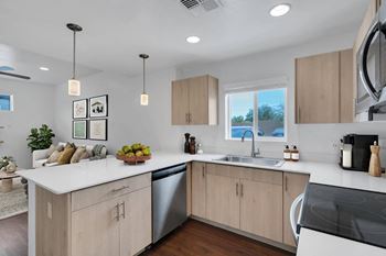 A modern kitchen with a large island and stainless steel appliances.